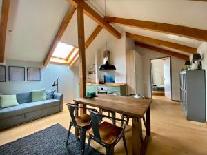 a kitchen and living room with a wooden table and chairs at Ferienwohnung Röthenbach in Oberaudorf