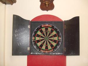 a dart board on a wall with a dartboard at The Denewood in Sandown