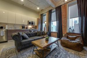 a living room with a couch and a table at Butler Brothers Building Suites in Dallas