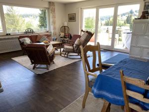 a living room with chairs and a couch and a table at Haus Gutach in Schonwald im Schwarzwald