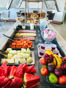 a buffet of cheese and fruit on a table at SHELTON PALACE HOTEL in Paranavaí