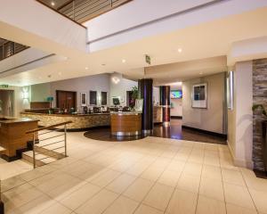 an empty lobby with a bar in the distance at Town Lodge Gaborone in Gaborone