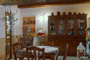 a dining room with a table and a cabinet at Agriturismo L'Ulivo in Fiore in Spoleto
