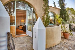 a house with a white gate in front of a house at Casa Los Arcos at Masia Nur Sitges, Adults only in Canyelles