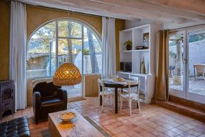 a living room with a table and a chair at Casa Los Arcos at Masia Nur Sitges, Adults only in Canyelles