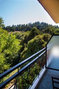 a balcony with a view of the forest at Hotel Adonis in Kriopigi