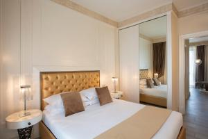 Postel nebo postele na pokoji v ubytování Suite Milano Duomo