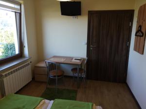a small room with a small table and a door at Rivabell in Ostrowo