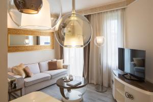a living room with a couch and a tv at Suite Milano Duomo in Milan