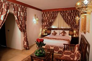 a bedroom with a large bed and a large window at Oriental Rivoli Hotel & Spa in Sharm El Sheikh