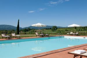a beach with a pool, chairs, and a pool table at Monsignor Della Casa Country Resort & Spa in Borgo San Lorenzo