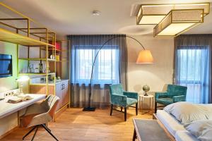 a bedroom with a bed and a desk and chairs at Biohotel-Restaurant Rose in Hayingen