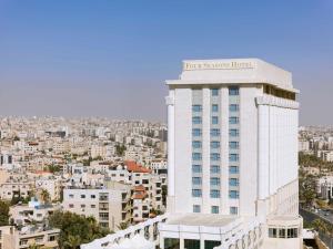 a large building with a clock on the top of it at Four Seasons Hotel Amman in Amman