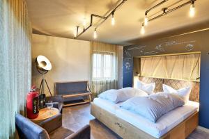 a bedroom with a large bed with white pillows at Biohotel-Restaurant Rose in Hayingen +42 photos
