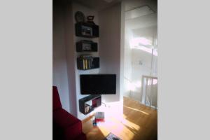 a living room with a flat screen tv on a wall at Stadtferienwohnung Lüneburg in Lüneburg