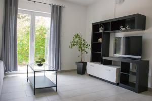a living room with a flat screen tv on a entertainment center at Holiday home I.D.A. in Banjole