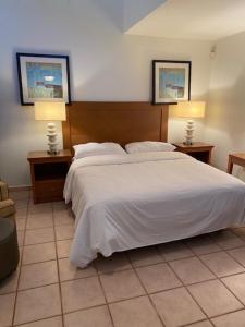 a bedroom with a large white bed with two lamps at Bahia Bay Resort in Key Largo