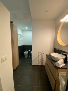 a bathroom with a sink and a toilet at Mood's Home in Avola