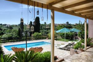 a pool with a view of a house at Villa Cottage Kantrillies in Kefallonia