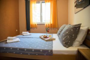 a bedroom with a bed with a tray of food on it at Apartmani M&C in Fažana