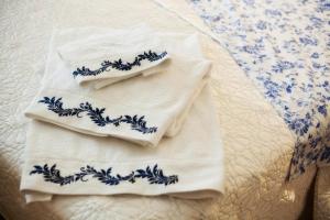 two blue and white towels sitting on a bed at Hotel Cardinal in Albacete