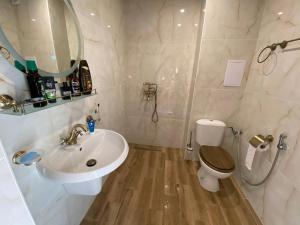 a bathroom with a sink and a toilet and a mirror at Sea View Marina Dinevi Apartments - Tryavna Beach in Sveti Vlas +30 photos
