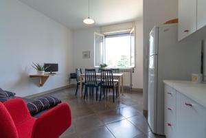 a kitchen and dining room with a table and chairs at Mamma Ciccia Holiday Home - Confalonieri in Mandello del Lario