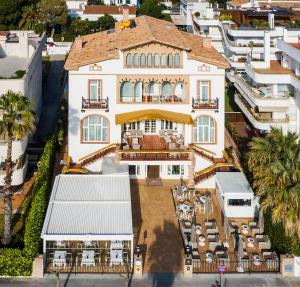 a large building with a clock on the front of it at Hotel Casa Vilella 4* Sup in Sitges