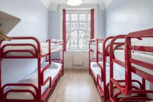 a room with four bunk beds in it with a window at Astor Hyde Park Hostel in London
