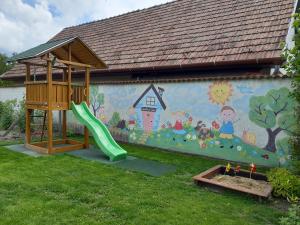 un parque infantil con un mural en el lateral de una casa en APARTMAN SOÓS -- Only for relaxation, not for party!, en Siófok