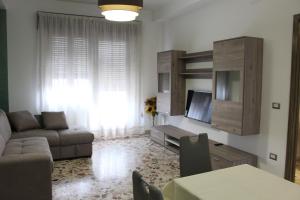 a living room with a couch and a tv at Taormina Etna Sea in Piedimonte Etneo