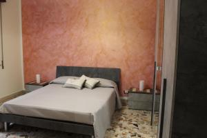 a bedroom with a bed with two night stands and two tables at Taormina Etna Sea in Piedimonte Etneo