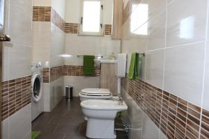 a bathroom with a white toilet and a sink at Taormina Etna Sea in Piedimonte Etneo +14 photos