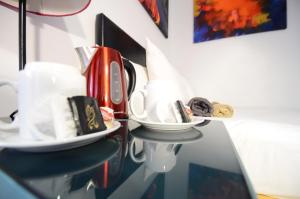 a table with a coffee maker and cups on it at Astor Hyde Park Hostel in London