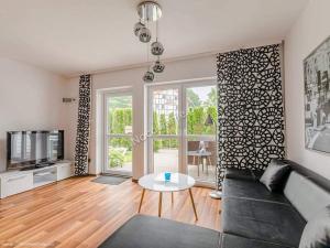 a living room with a couch and a table at APARTAMENTY-Villa Żeglarzy in Rusinowo