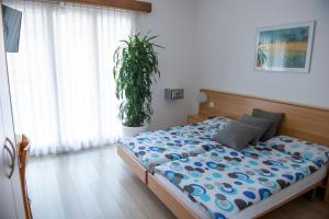 Rúm í herbergi á Garni Moderno