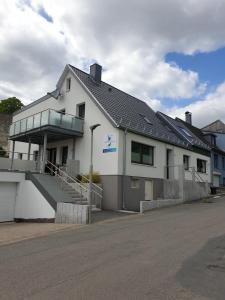 a white building with a staircase in front of it at Ferienwohnung Am Polierteich in Schleswig