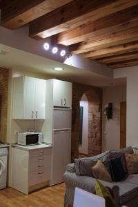 a living room with a couch and a kitchen at Centro Historico Universidad LA RANITA SALMANTINA in Salamanca