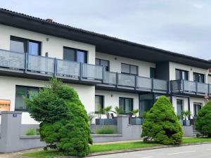 an apartment building with trees in front of it at Haus Pannonsee in Podersdorf am See