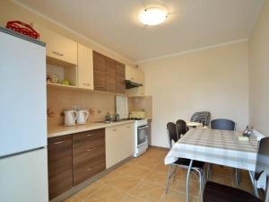 a kitchen with a table and a table and a refrigerator at Dafne 2 in Niechorze