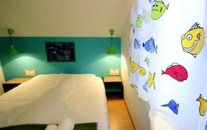 a bedroom with a bed with a wall covered in stickers at Apartments Mizo in Ohrid