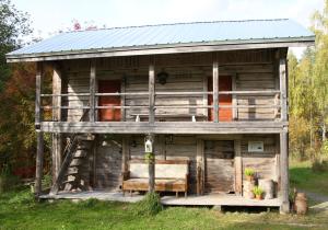 an old cabin with a porch and a couch in it at Kolin Keidas in Kolinkyl&auml;