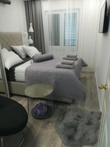 Postel nebo postele na pokoji v ubytování Apartmani Vidoš
