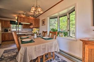 a kitchen and dining room with a table and chairs at Lake Superior Beachfront Home - 15 Mi to Duluth! in Clifton