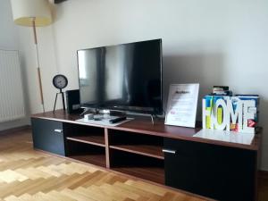 a desk with a large television on top of it at Apartment Angelus in Zagreb