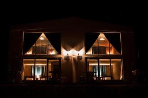 a dimly lit room with a large window at Zeina Desert Lodge in Wadi Rum
