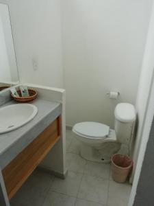 a bathroom with a white toilet and a sink at Hotel Quinta Paraiso in Cocoyoc