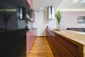a kitchen with a wooden counter top in a room at Glam Brewery Suite - Deluxe Apartment with Parking in Krakow