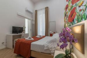 Tempat tidur dalam kamar di Hotel Mimosa Pantheon