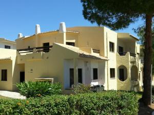 a large white house with trees in front of it at Aguileras in Alvor